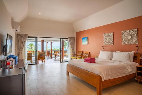 a bedroom with a large bed and a balcony at Crystal Bay Yacht Club Beach Resort in Lamai