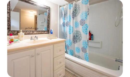 a bathroom with a sink and a shower curtain at Bright Room in Walkout Basement in Pickering