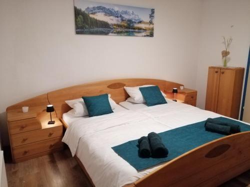 a bedroom with a large white bed with blue pillows at Allgäu Space in Marktoberdorf