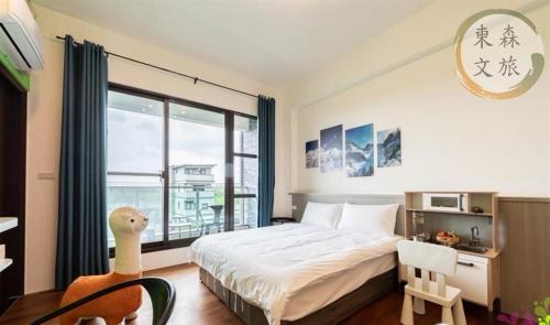 a bedroom with a bed and a large window at 象日葵民宿-寵物友善-無門禁24小時進出-免費停車-東森文旅-包棟優惠中 in Wujie