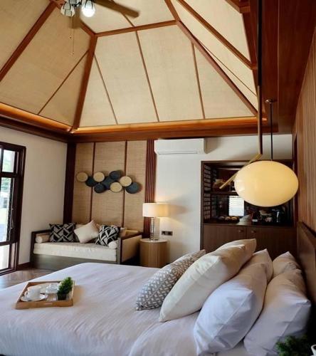 a bedroom with a large white bed in a room at Brio de Agoho in Candelaria