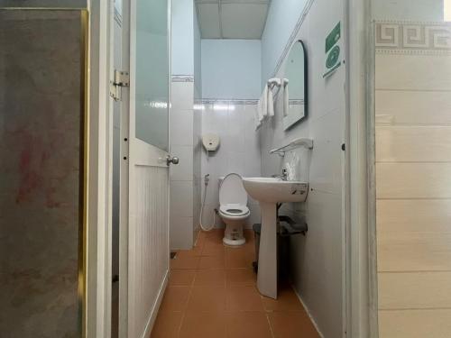 a small bathroom with a toilet and a sink at Kim Long Hotel in Can Tho