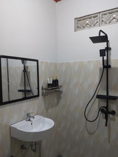 a bathroom with a sink and a shower at Traveling Guest House - Shared Kitchen in Kuta Lombok
