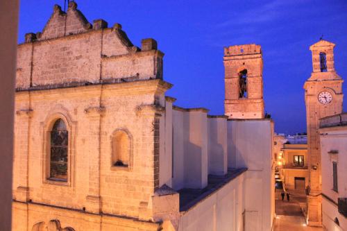 an old building with two towers and a clock tower at Dimore Santagaeta in Racale
