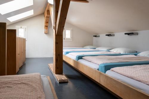 a row of beds in a room at Zermatt Youth Hostel in Zermatt