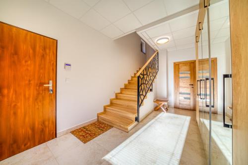 a hallway with a staircase in a house at Vila SIGORD in Kokošovce