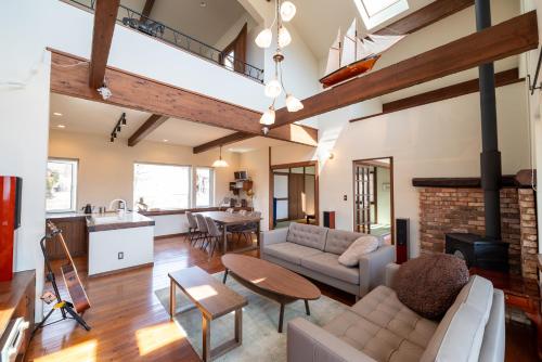 a living room with a couch and a table at ReTune Hokuto in Hokuto