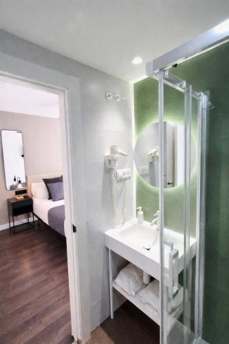 a bathroom with a sink and a shower at Apartamentos Carmen del Turia in Valencia