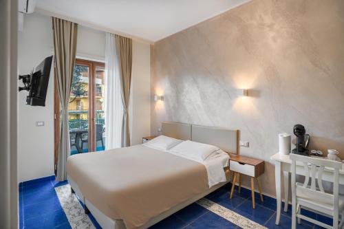 a hotel room with a bed and a window at The Reef Sorrento in Sorrento