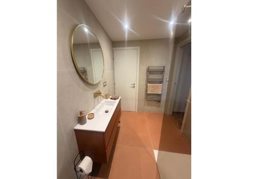 a bathroom with a sink and a mirror at La maison des vacances in Menton