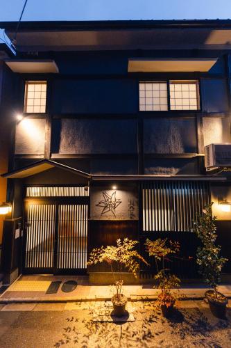 a building with two potted plants in front of it at Kyoto Amazing The Wizarad of Oz in Kyoto