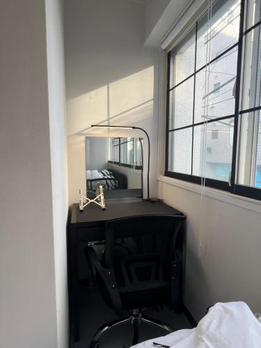 a bathroom with a mirror and a sink at Kuro House - In the middle of Hiro, Omotesando, Roppongi in Tokyo