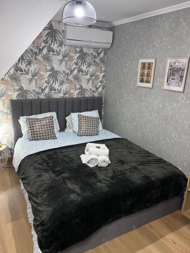 a bedroom with a large bed with a black blanket at coração alfama in Lisbon