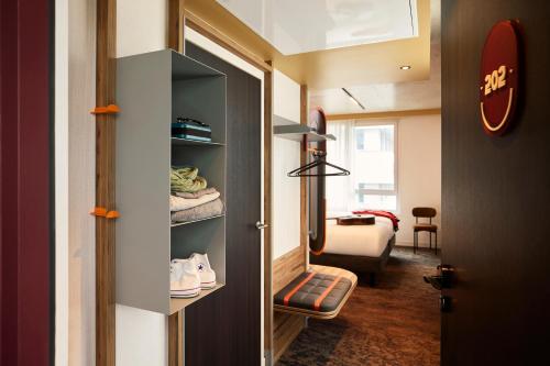 a room with a door open to a room with a room at You Hotel Amiens - Handwritten Collection in Amiens