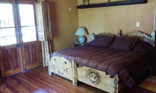 a bedroom with a large bed in a room at Finca La Encantada in San Rafael