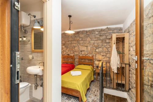 a bedroom with a bed and a sink in a room at Climbing House in Baunei