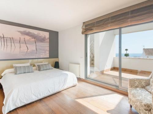 a bedroom with a bed and a large window at R64 Deluxe Villa Déjà Vu in Calafell