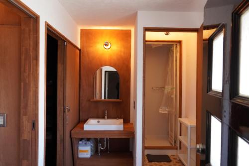 a bathroom with a sink and a mirror at 灯GuestHouse in Aizuwakamatsu