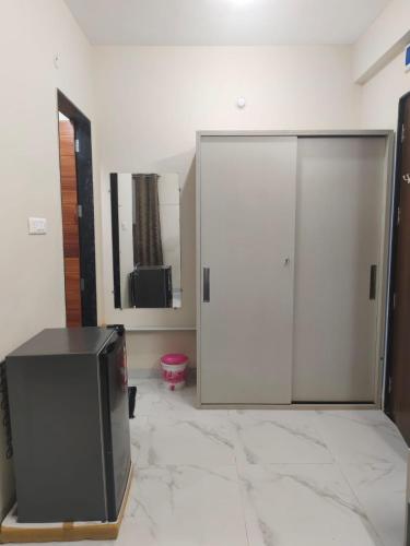 a living room with a tv and a mirror at Ramashraya in Indore