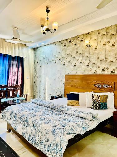 a bedroom with a large bed in a room at Hotel Marvi Multan in Multan