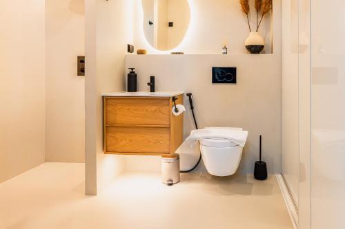 a bathroom with a sink and a toilet at New Seaside Villa with Beach Sauna and Panoramic Views in Porvoo