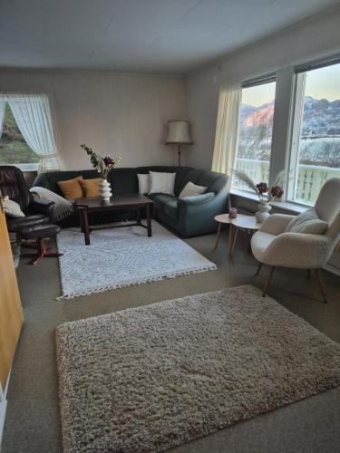 a living room with a couch and a table at House by Ramberg Beach in Ramberg