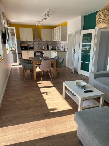 a living room with a table and a kitchen at Green view 180 in Troyan