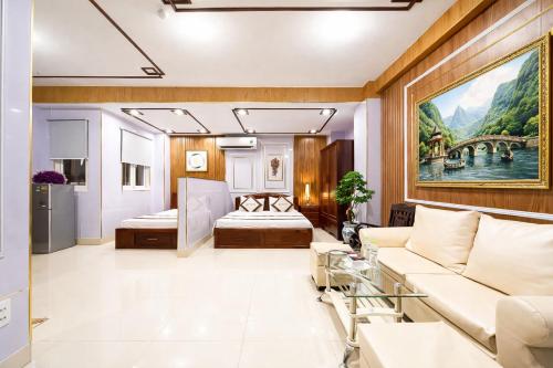 a living room with a couch and a bed at Diamond Luxury Ben Thanh in Ho Chi Minh City