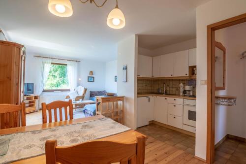 a kitchen and living room with a table and chairs at Wabnig- der Logenplatz in der Natur in Moosburg