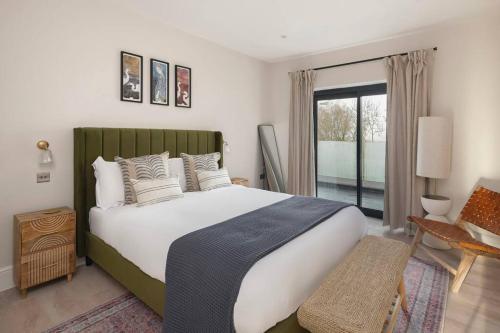 a bedroom with a large bed and a window at Brockview House - Eco 4 bed in Holcombe