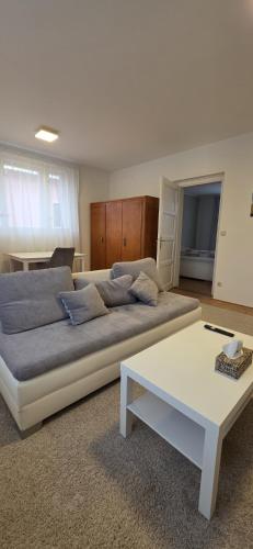 a bedroom with a large bed and a white table at Apartmán Na Polabí 2 in Mělník