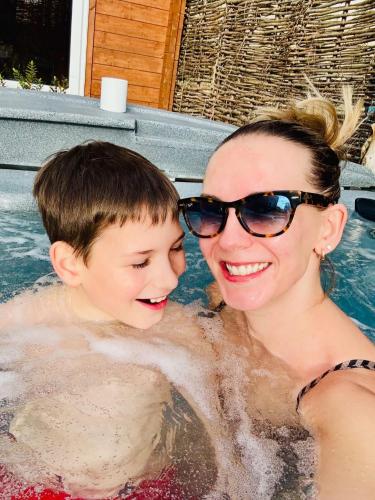 a woman and a boy in a swimming pool at Lady Lily Spring Unique River Boat with Castle views in Allington