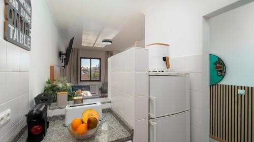 a kitchen with a bowl of fruit on a counter at The Seaview Studio by LovelyStay in Caniço