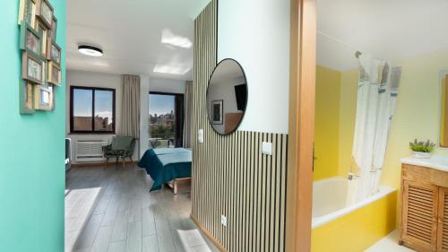 a room with a bathroom with a bed and a tub at The Seaview Studio by LovelyStay in Caniço