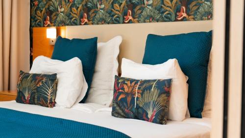 a bedroom with a bed with blue and white pillows at The Seaview Studio by LovelyStay in Caniço
