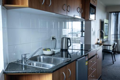 a kitchen with a sink and a counter top at 1 Bedroom Apartment In the heart of Parramatta CBD in Sydney