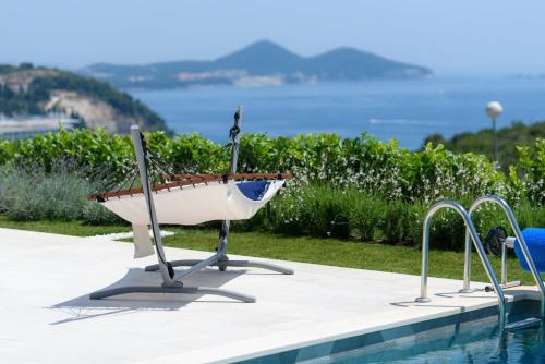 a boat sitting next to a swimming pool at Villa Soderini in Dubrovnik