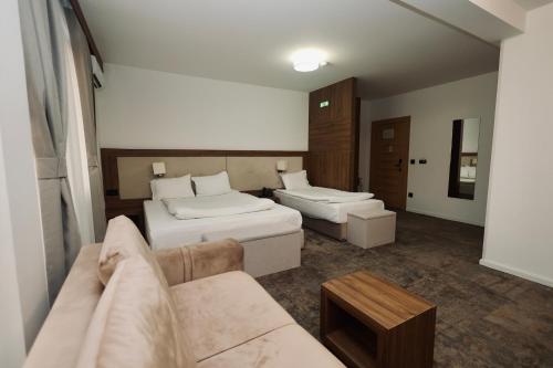 a living room with two beds and a couch at Aqua Spa Lux in Novi Pazar