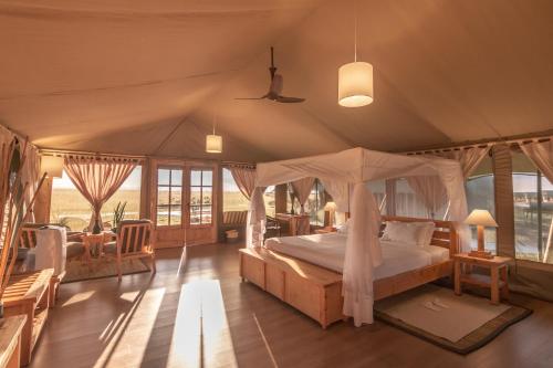 a bedroom with a canopy bed in a tent at MAISHA SWEETWATERS CAMP in Ol Pejeta Conservancy