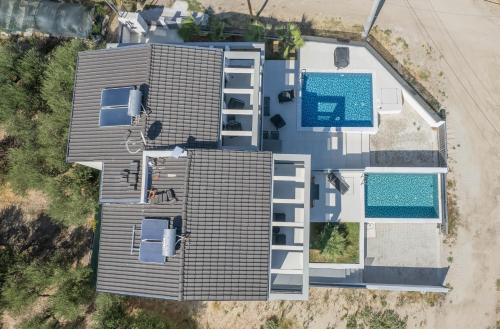 an overhead view of a house with a swimming pool at LUKA VILLAS Plage in Polychrono