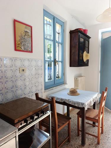 a kitchen with a table and chairs in a room at La Panciotta in Azzano