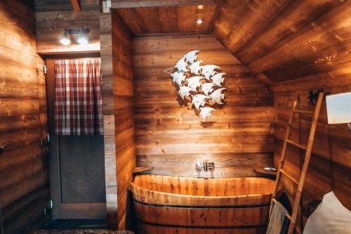 a room with a wooden wall with cows on the wall at Aqualodge Hôtel Insolite in Ermeton-sur-Biert