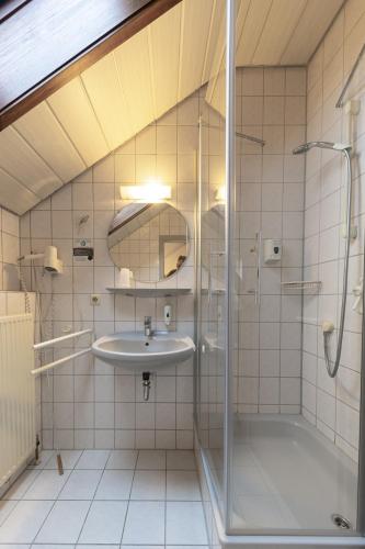 a bathroom with a sink and a shower at Pension Krone in Schwäbisch Gmünd