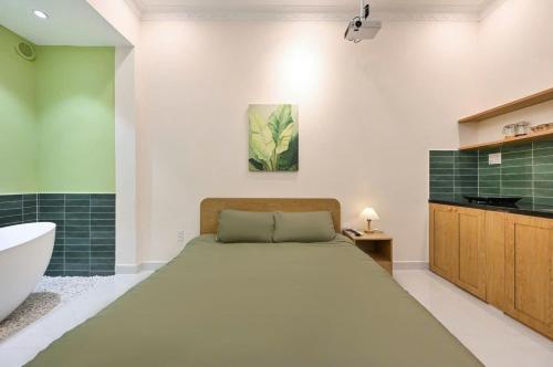 a bedroom with a bed and a tub and a sink at Sai Gon Stay-Hi-Tech Park Collection in Ho Chi Minh City