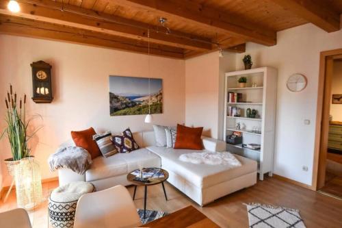 a living room with a couch and a table at Charmante Chiemgauwohnung in Wasserburg am Inn