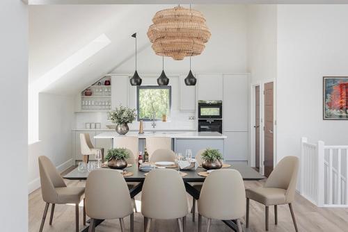 a kitchen and dining room with a table and chairs at Hill View House - Cookswood in Holcombe