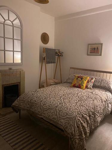 a bedroom with a bed and a fireplace at Central London Flat 2 bathrooms in London