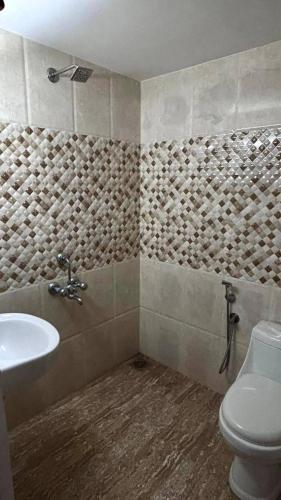 a bathroom with a sink and a toilet at Well maintained Calm atmosphere in Putuppalli