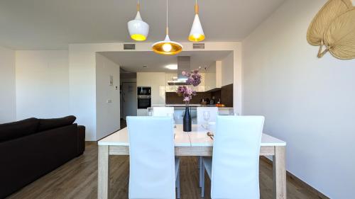 a kitchen and dining room with a table and chairs at ALLONBAY spa & beach house in Villajoyosa