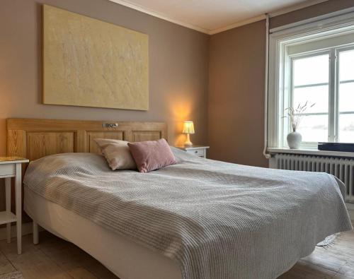 a bedroom with a large bed with a blanket at Kiladalens Golf & Lodge in Nyköping